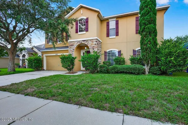 a kitchen with stainless steel appliances granite countertop a stove top oven a sink dishwasher a refrigerator and cabinets with wooden floor
