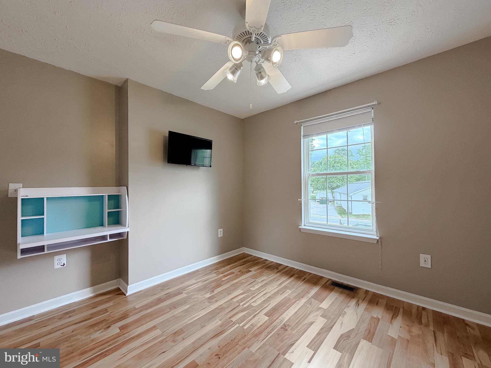 23801 McIntosh Road Hollywood, MD 20636 - Photo 19 of 35 an empty room with wooden floor and windows
