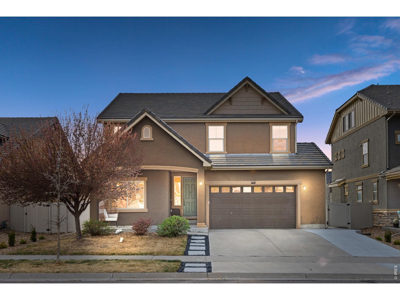 148 Summit Way Erie, CO 80516 - Photo 1 of 47 a front view of a house with a yard and garage