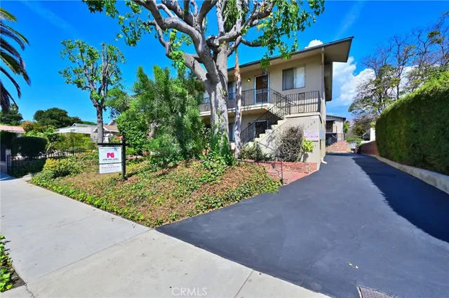 a front view of a house with a yard and a garage