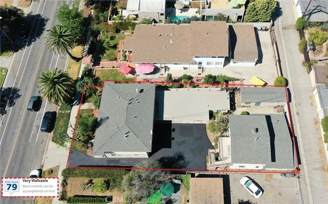 a front view of a house with a yard and potted plants