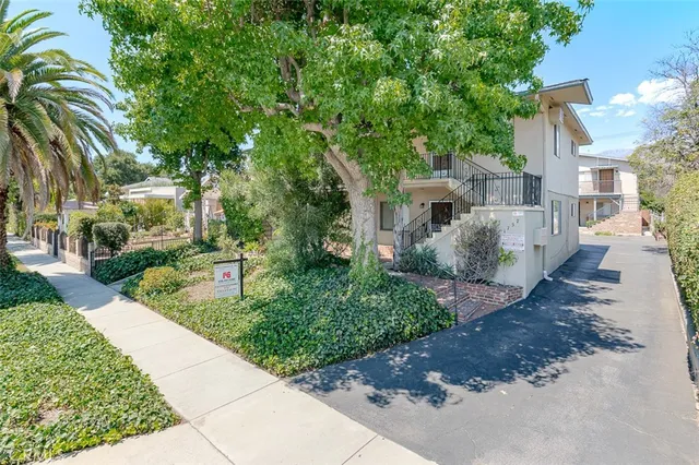 a aerial view of a house with a yard and potted plants