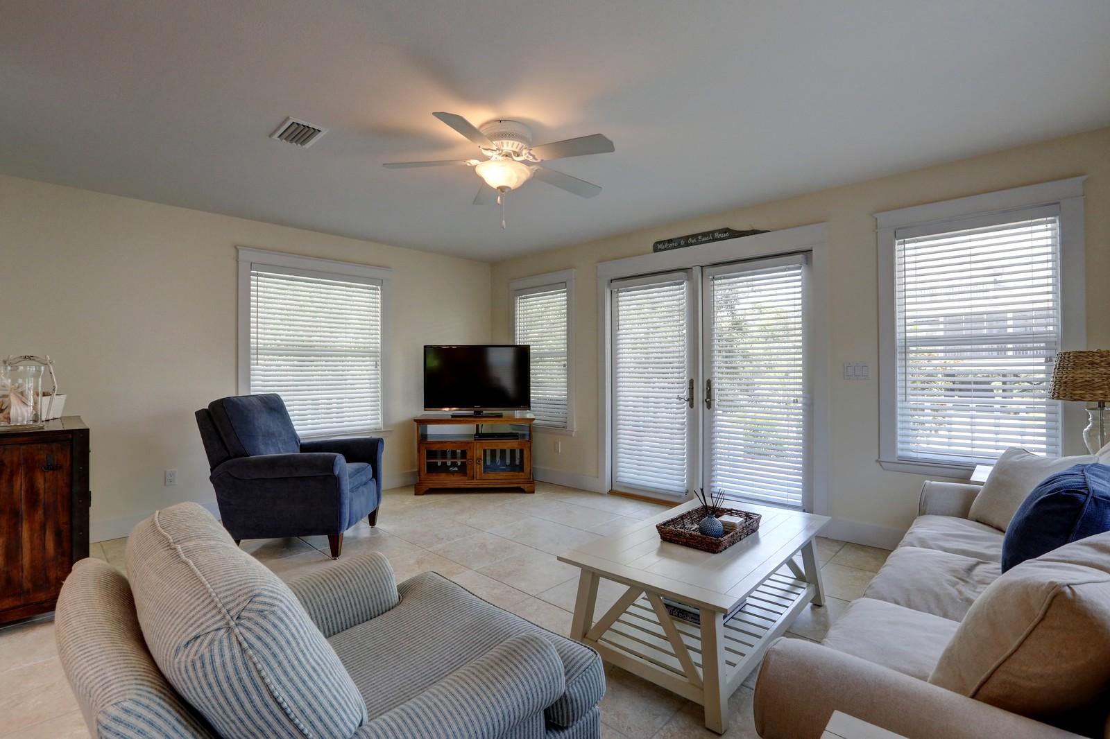 97 Sand Dunes Road Santa Rosa Beach, FL 32459 - Photo 14 of 31 a living room with furniture and a flat screen tv