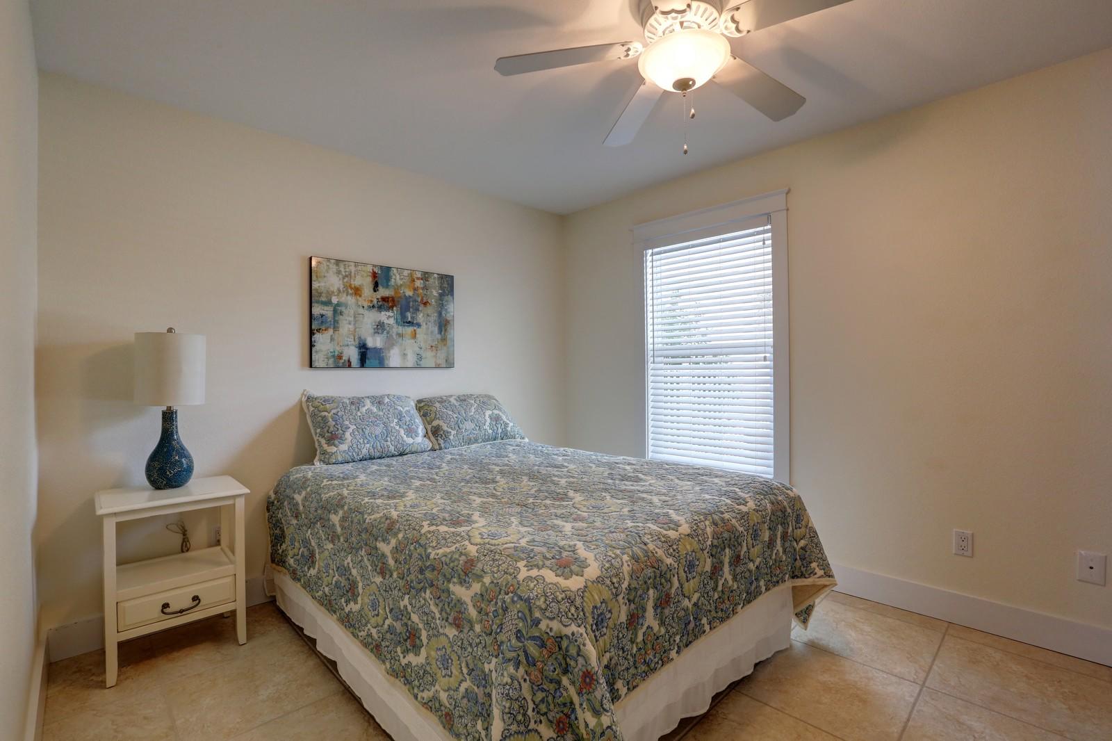 97 Sand Dunes Road Santa Rosa Beach, FL 32459 - Photo 18 of 31 a bedroom with a bed and a chandelier
