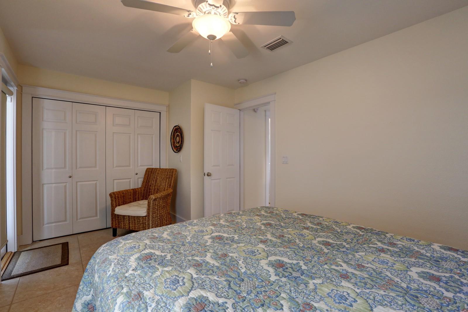 97 Sand Dunes Road Santa Rosa Beach, FL 32459 - Photo 19 of 31 a bedroom with a bed and a chandelier