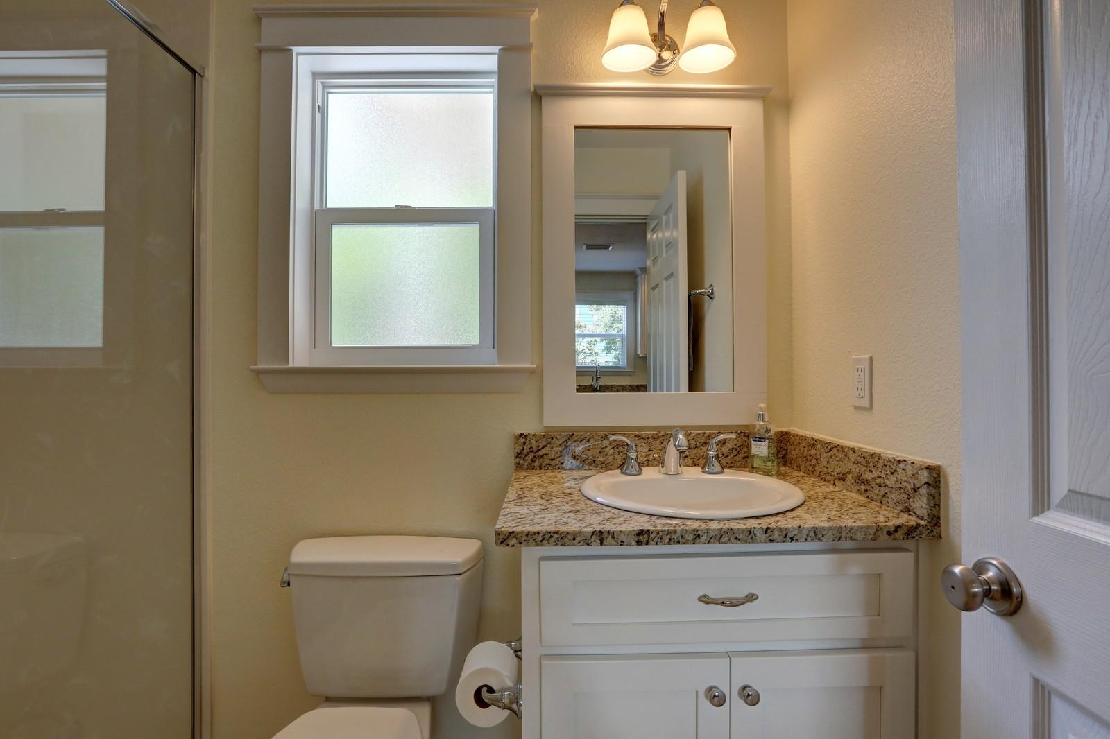 97 Sand Dunes Road Santa Rosa Beach, FL 32459 - Photo 20 of 31 a bathroom with a granite countertop sink toilet and mirror