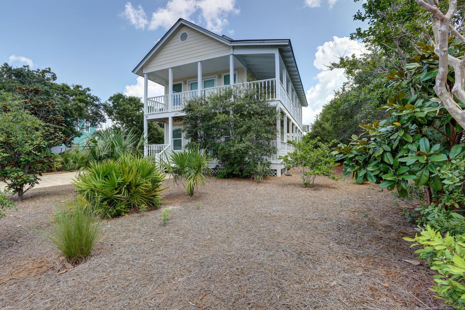 97 Sand Dunes Road Santa Rosa Beach, FL 32459 - Photo 3 of 31 a view of a house with potted plants and large trees