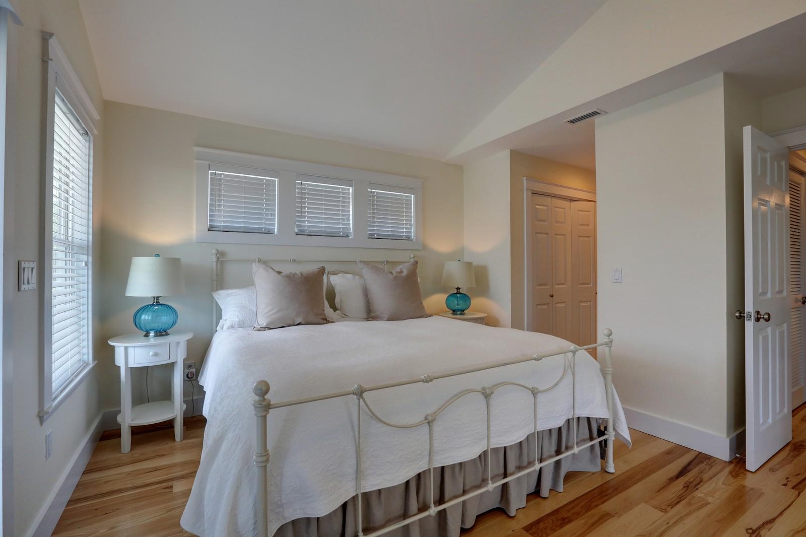 97 Sand Dunes Road Santa Rosa Beach, FL 32459 - Photo 26 of 31 a bedroom with a bed and wooden floor