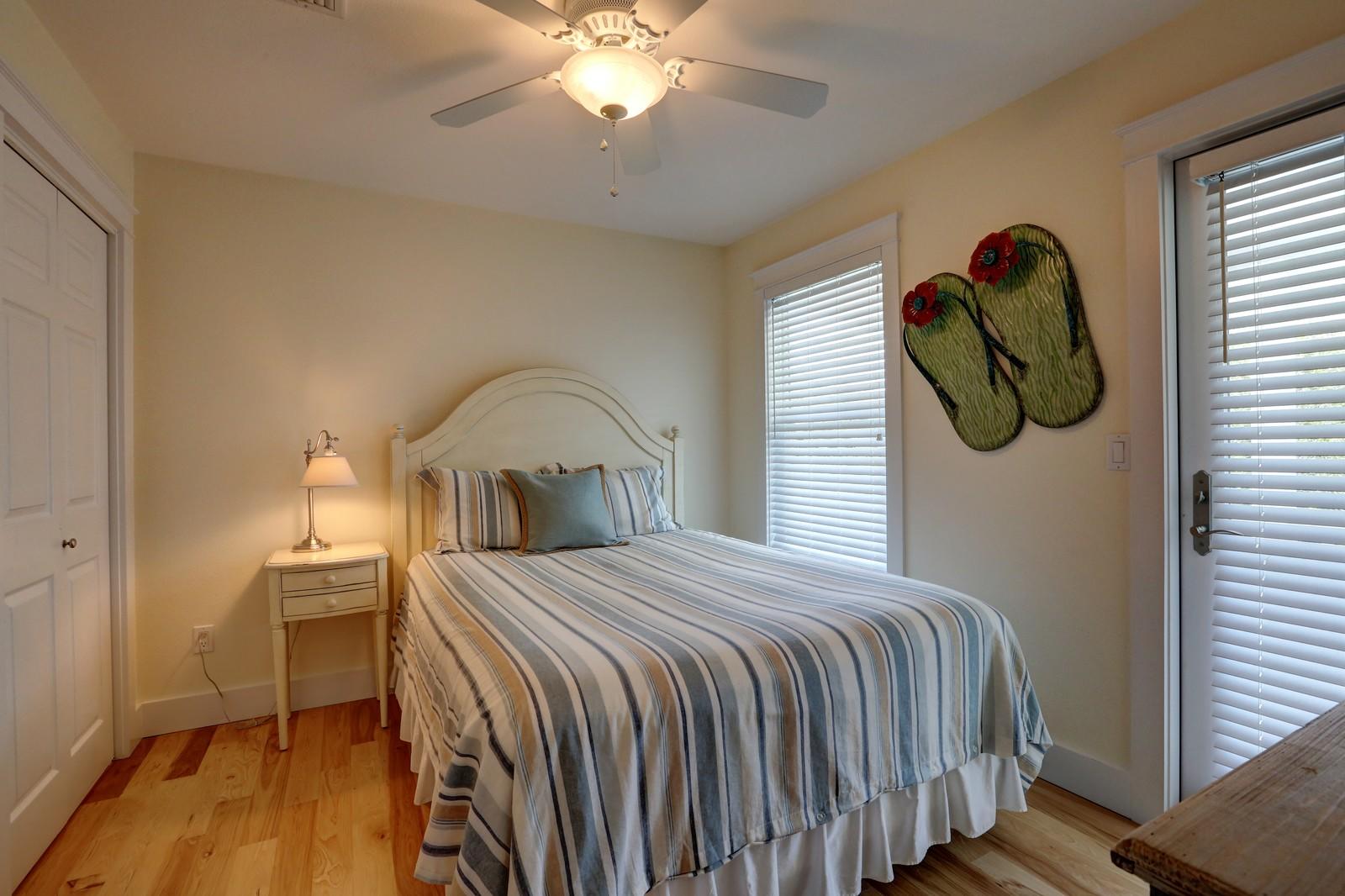 97 Sand Dunes Road Santa Rosa Beach, FL 32459 - Photo 28 of 31 a bedroom with a bed and a chandelier