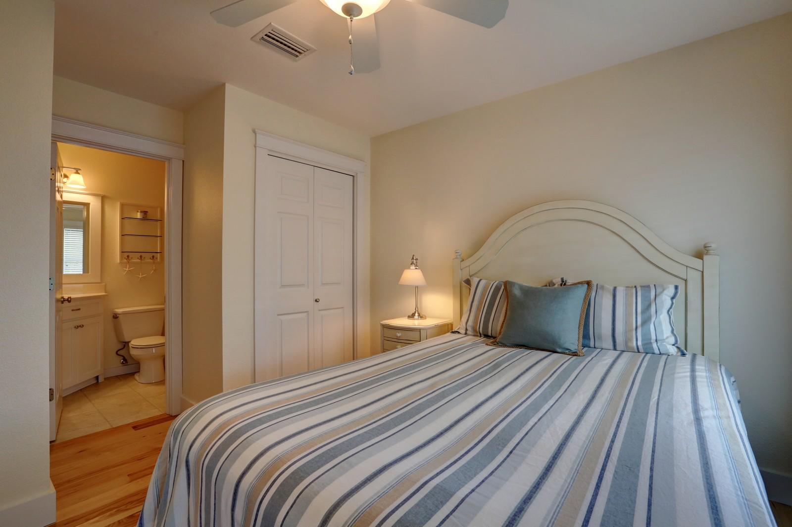 97 Sand Dunes Road Santa Rosa Beach, FL 32459 - Photo 29 of 31 a bedroom with a large bed and a chandelier