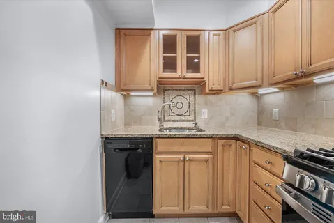 a kitchen with stainless steel appliances granite countertop a stove microwave and refrigerator
