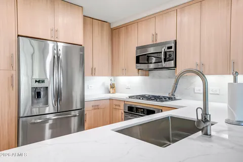 a kitchen with a refrigerator stove and microwave