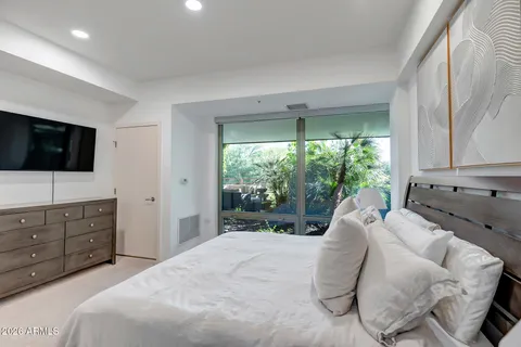 a bed room with a bed and a television