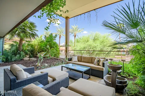a roof deck with couches and potted plants
