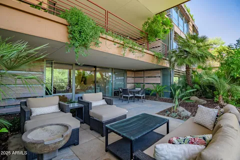 a view of a patio with couches table and chairs and potted plants