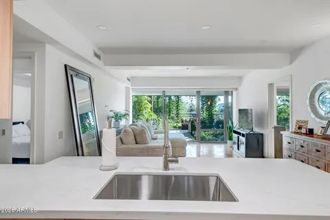 a kitchen with a sink a counter top space and a large window