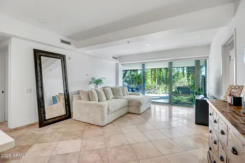 a living room with furniture and large windows