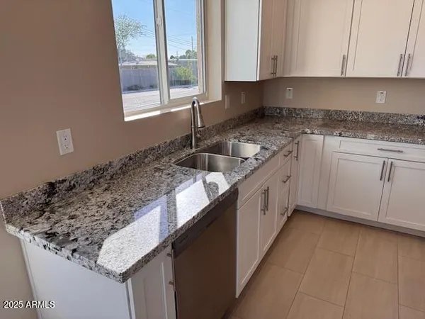 a kitchen with a sink and cabinets