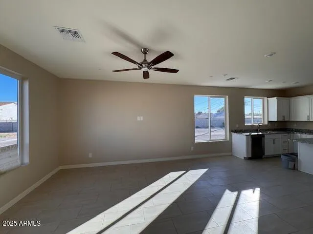a view of an empty room with brick wall and a window