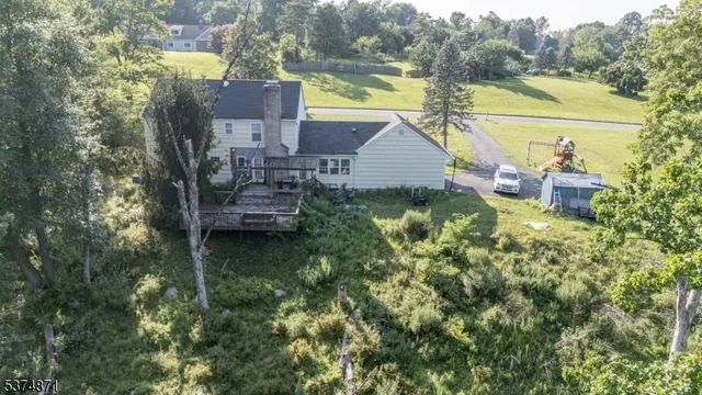 an aerial view of a house with outdoor space and lake view