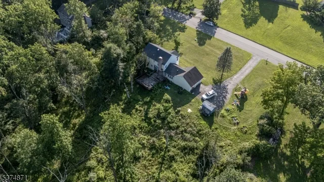 an aerial view of a house with a yard and lake view