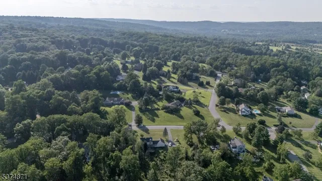 an aerial view of a house with a street