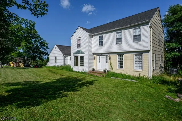 a view of a house with a backyard