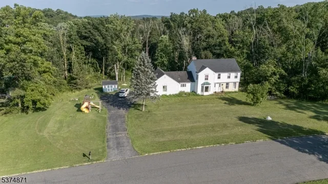 an aerial view of a house with a yard and lake view