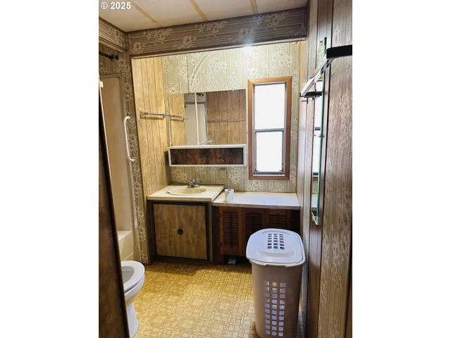 a bathroom with a sink a mirror and bathtub