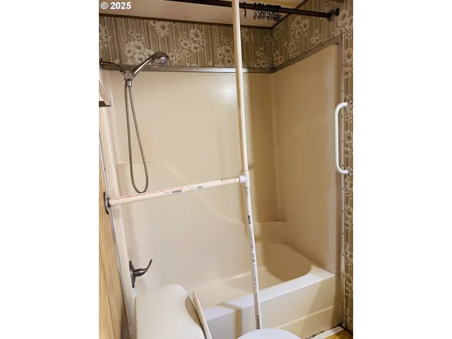 a bathroom with a glass shower door