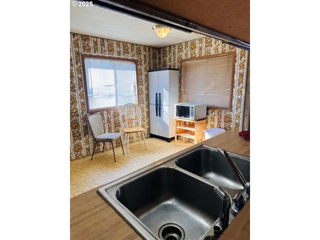 a kitchen with a sink and a stove top oven