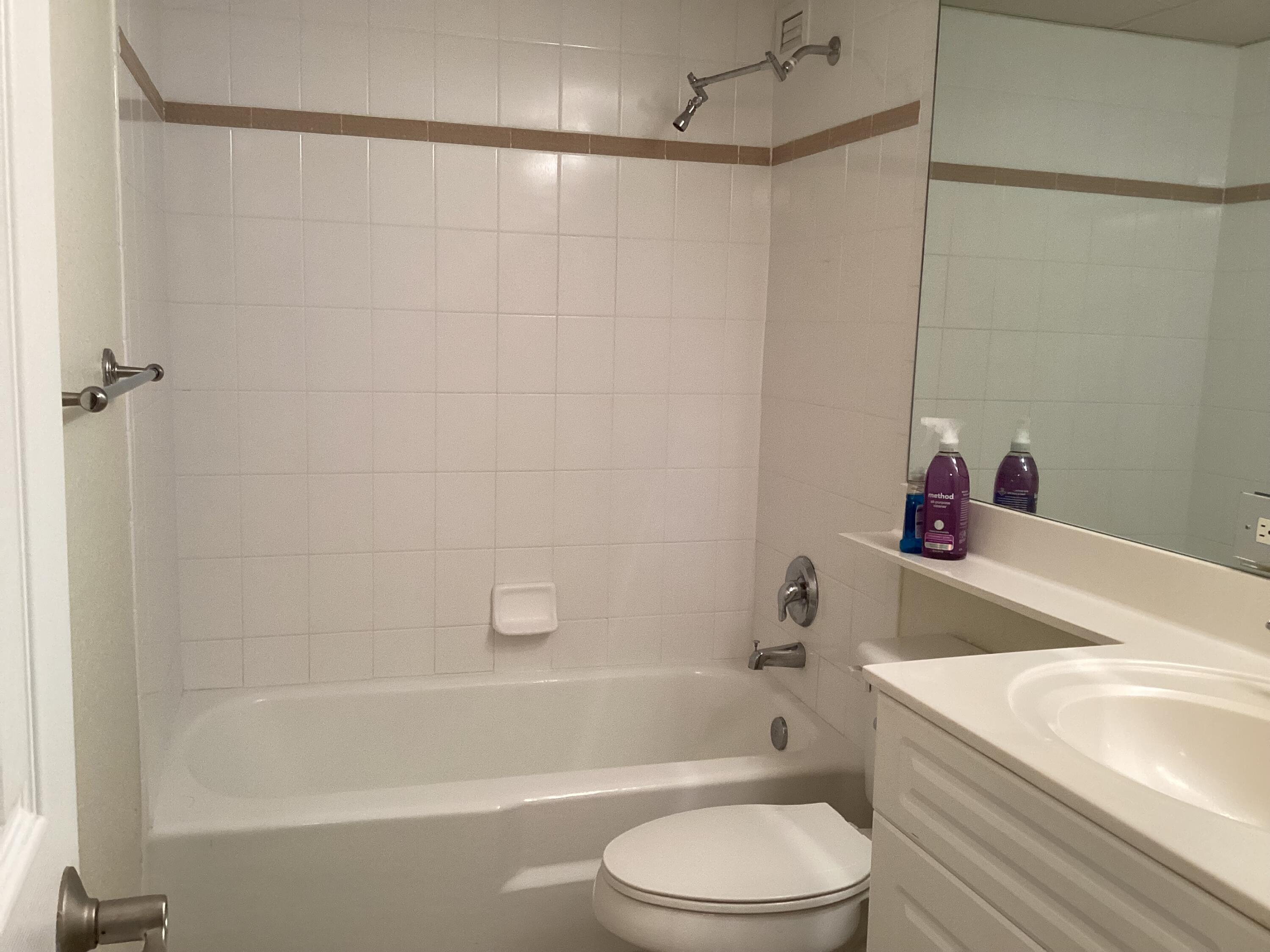 1000 Spanish River Road, Unit 3K Boca Raton, FL 33432 - Photo 14 of 32 a white bath tub sitting next to a white sink and a toilet