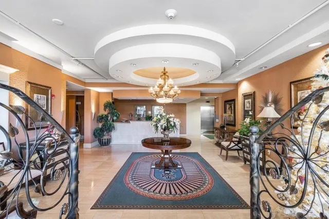 a dining room with furniture and a chandelier