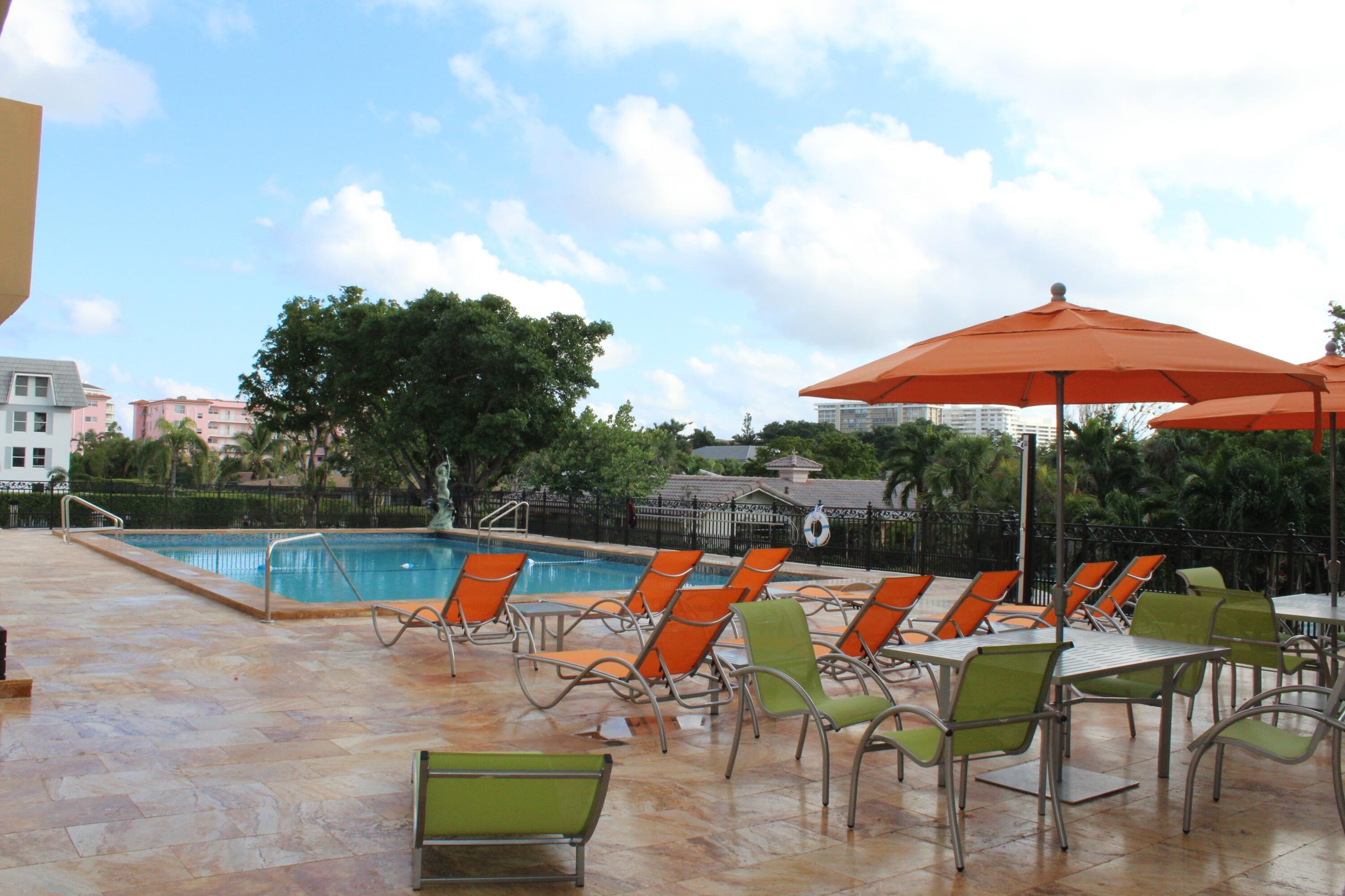 1000 Spanish River Road, Unit 3K Boca Raton, FL 33432 - Photo 27 of 32 an outdoor space with furniture and umbrella