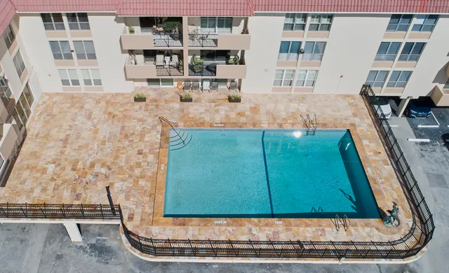 a living room with furniture a table and kitchen view