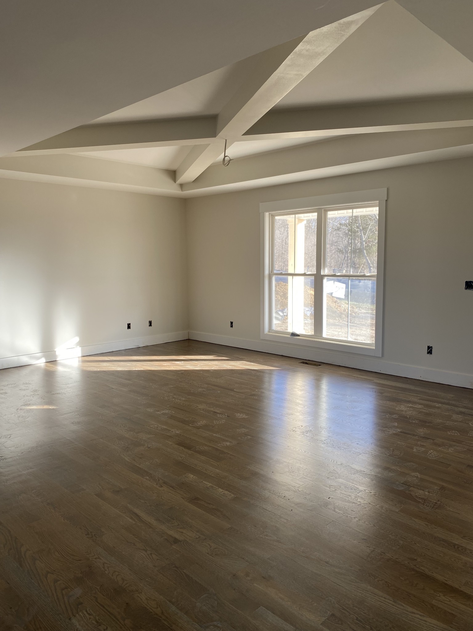 1011 North Corinth Road Portland, TN 37148 - Photo 3 of 5 an empty room with wooden floor and windows with curtains