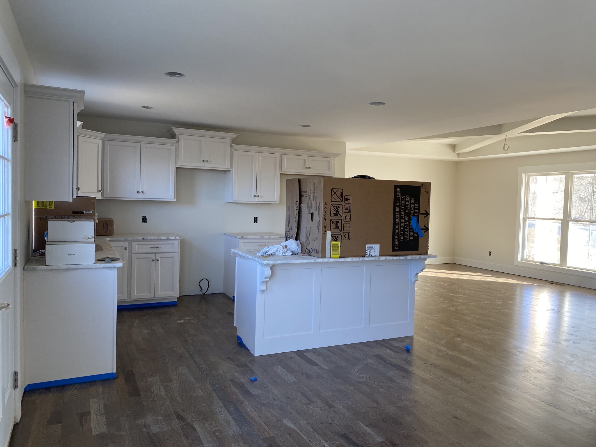 1011 North Corinth Road Portland, TN 37148 - Photo 4 of 5 a living room with stainless steel appliances kitchen island wooden floors and white walls