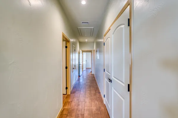 a view of a hallway with wooden floor