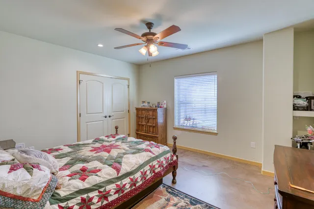 a bedroom with a bed and a chandelier
