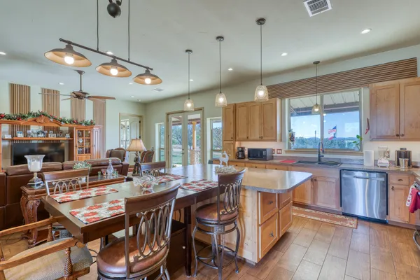 a large kitchen with a table and chairs