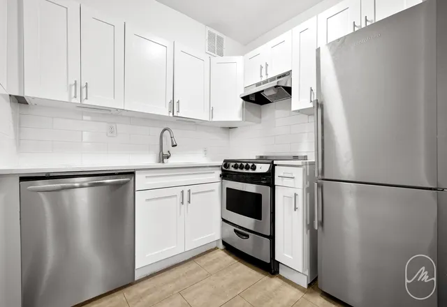 a kitchen with stainless steel appliances a refrigerator sink and cabinets