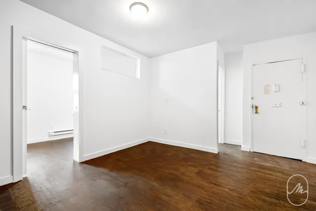 an empty room with wooden floor
