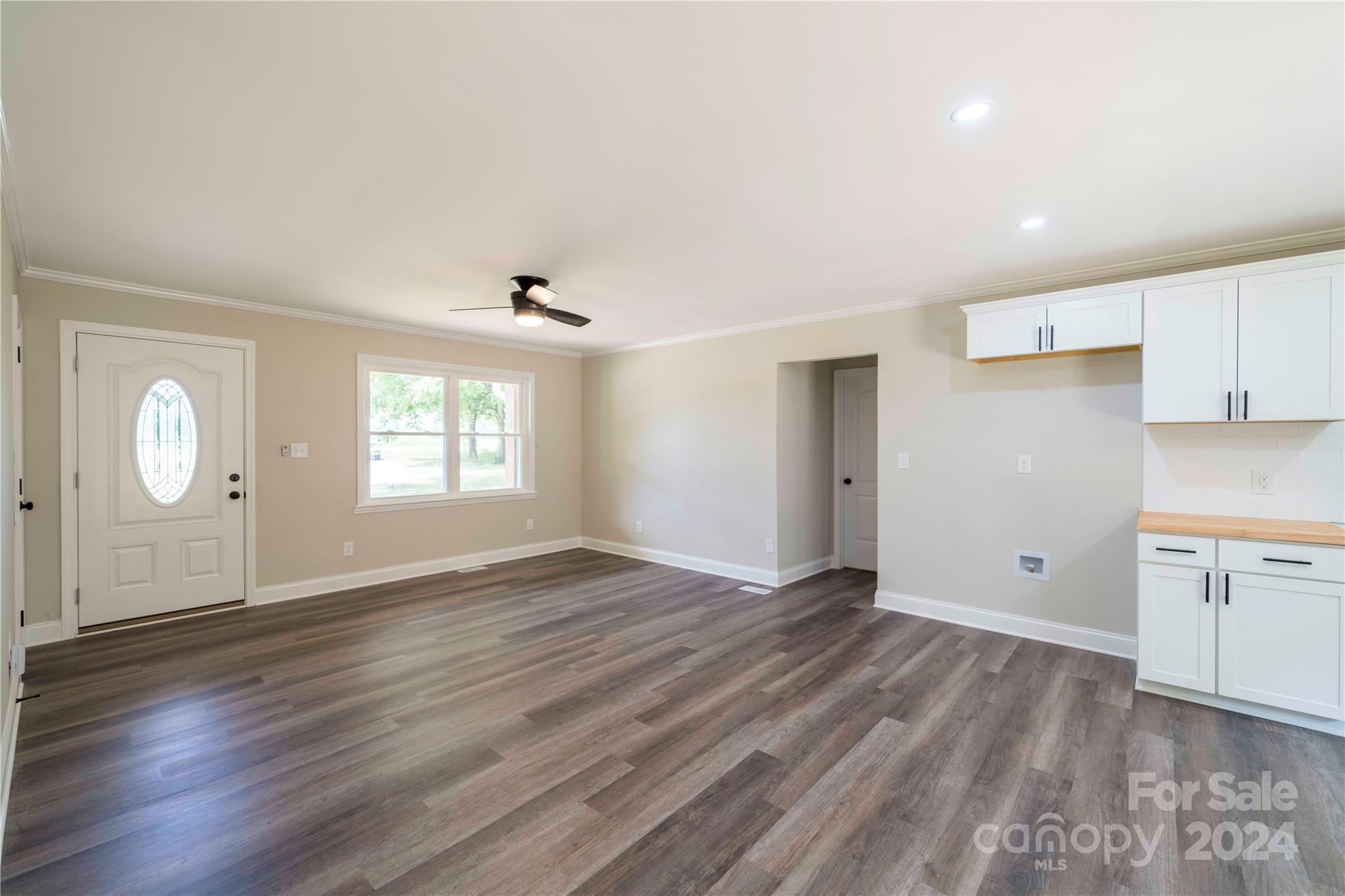 8225 Woodleaf Road Woodleaf, NC 27054 - Photo 13 of 40 an empty room with wooden floor cabinet and windows