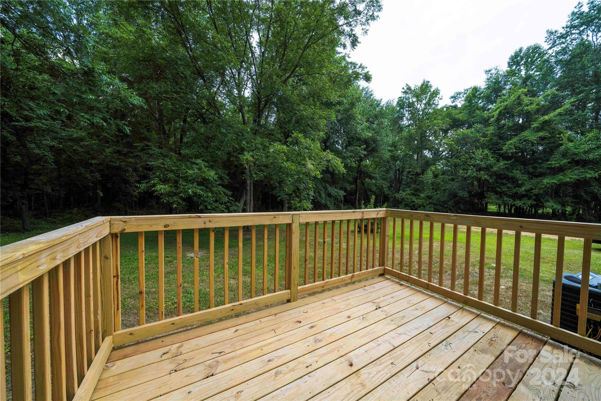 8225 Woodleaf Road Woodleaf, NC 27054 - Photo 26 of 40 a balcony with wooden floor and fence