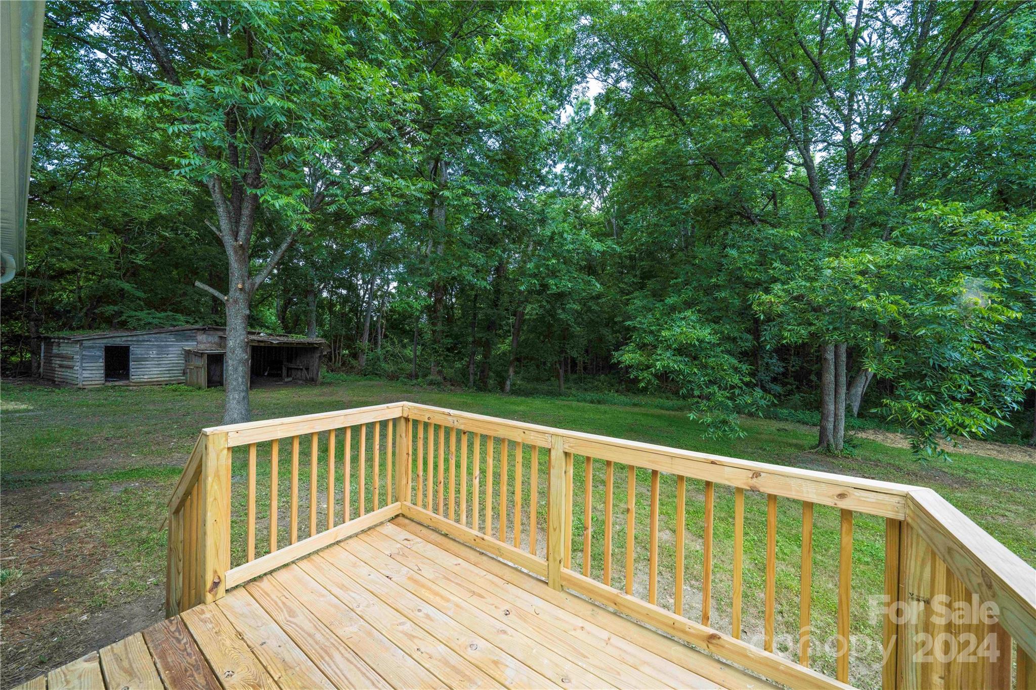 8225 Woodleaf Road Woodleaf, NC 27054 - Photo 27 of 40 a view of backyard with deck and garden