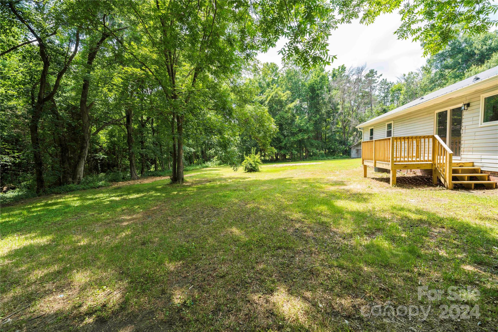 8225 Woodleaf Road Woodleaf, NC 27054 - Photo 30 of 40 a view of a house with a big yard