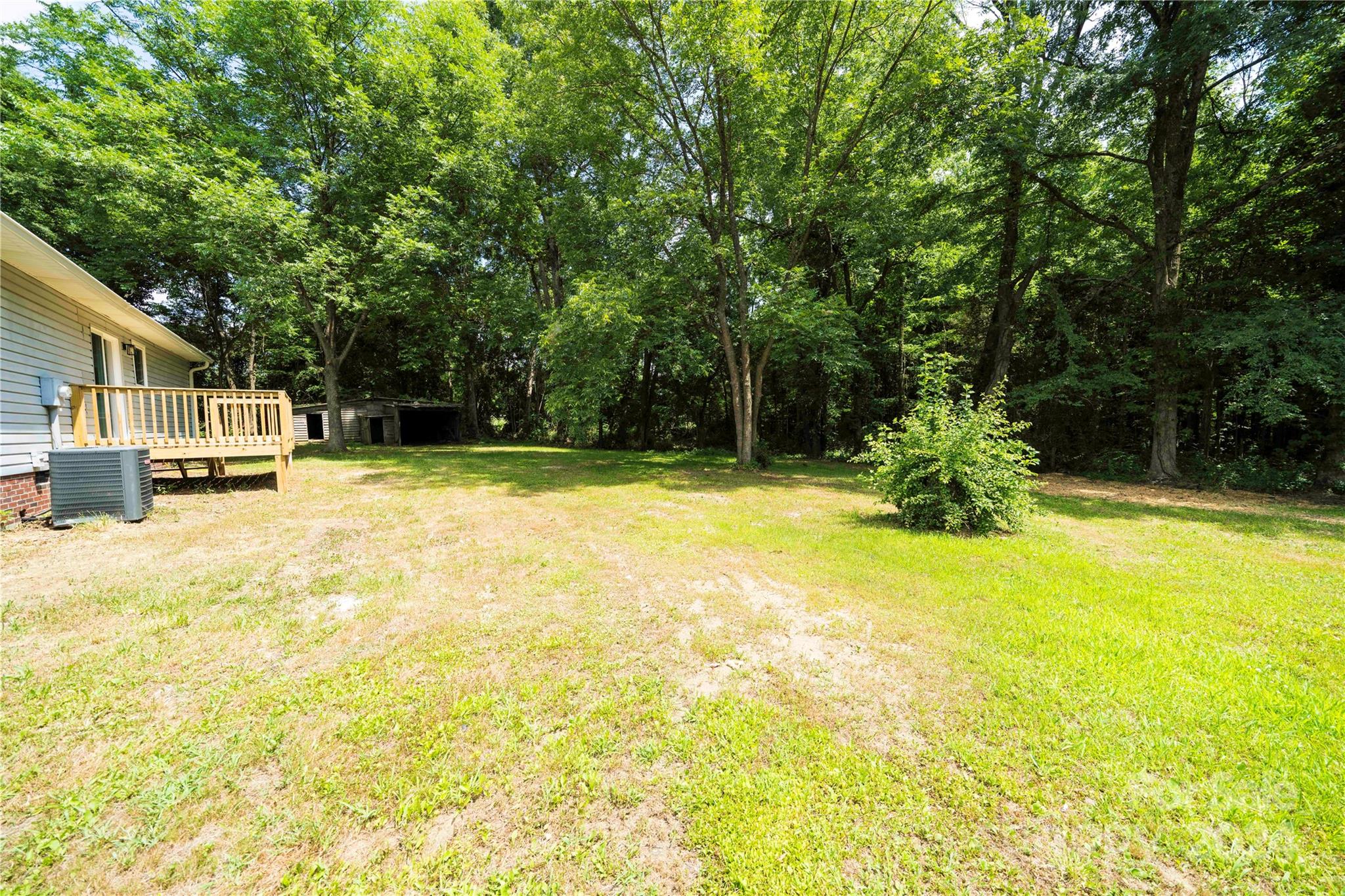 8225 Woodleaf Road Woodleaf, NC 27054 - Photo 31 of 40 a swimming pool with trees in front of it