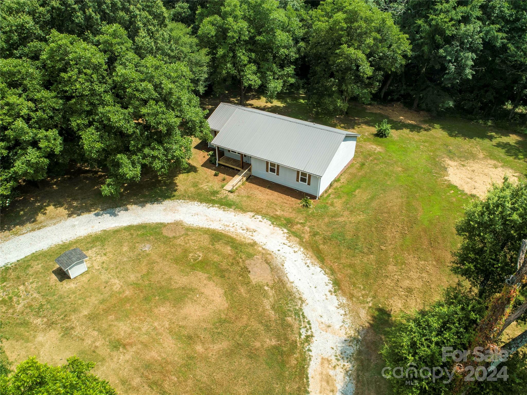 8225 Woodleaf Road Woodleaf, NC 27054 - Photo 36 of 40 a view of a yard with an outdoor space