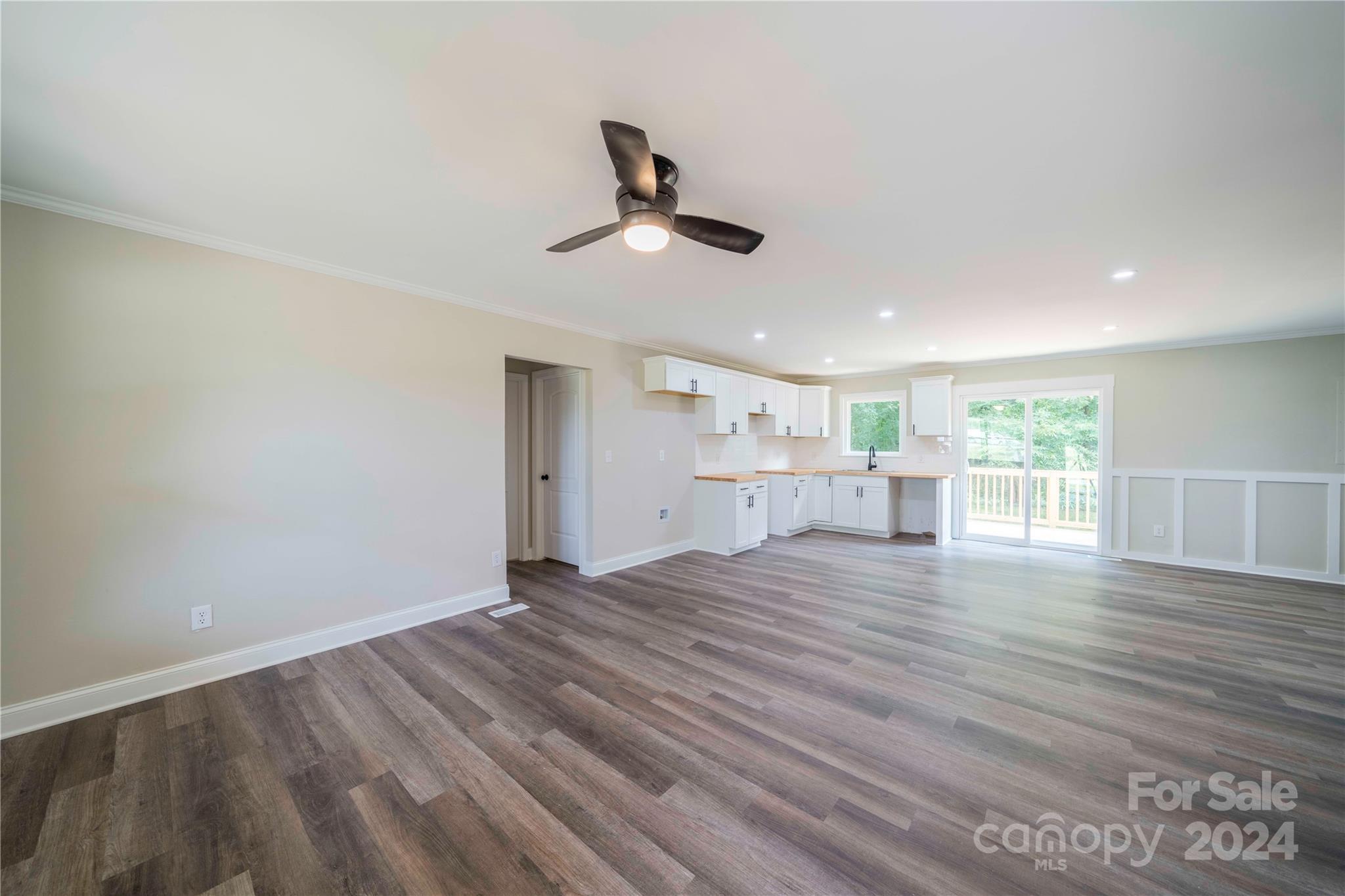 8225 Woodleaf Road Woodleaf, NC 27054 - Photo 7 of 40 a view of an empty room with wooden floor and a window