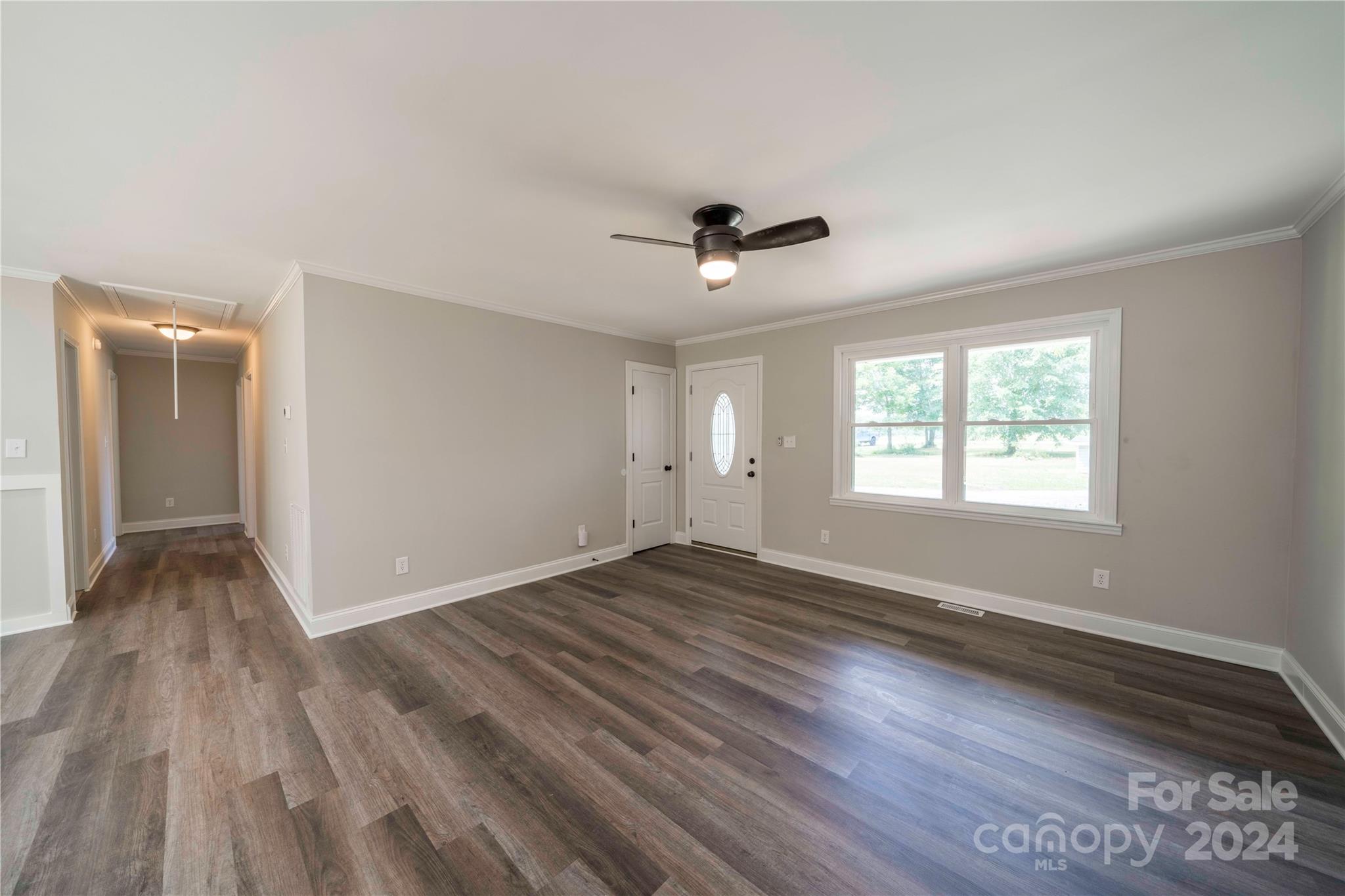 8225 Woodleaf Road Woodleaf, NC 27054 - Photo 8 of 40 an empty room with wooden floor and windows